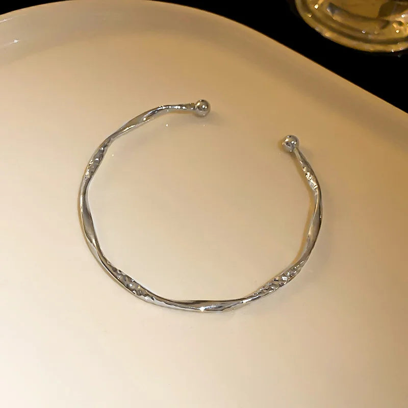Minimalist bamboo gold bangle with glossy finish
